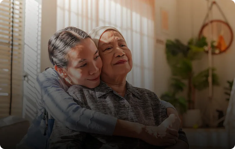 An older couple sitting close together and smiling