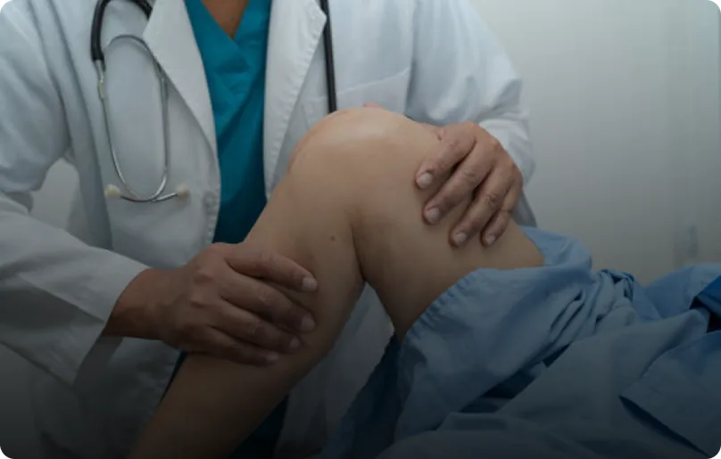 A clinician examining a patient's knee